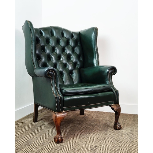 209 - A GEORGE III STYLE WING BACK ARMCHAIR, green leather, raised on cabriole legs with claw and ball fee... 