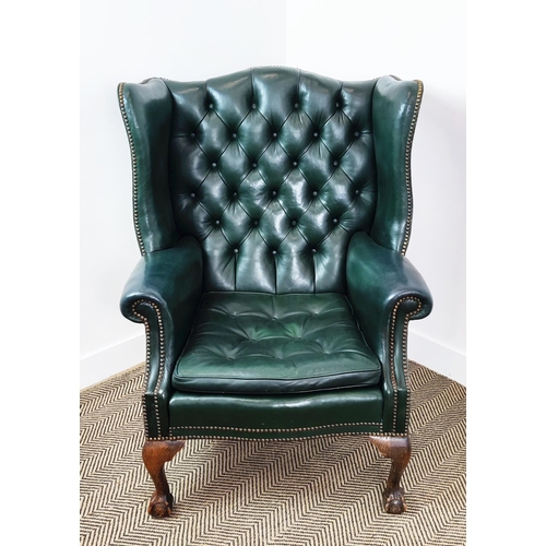 209 - A GEORGE III STYLE WING BACK ARMCHAIR, green leather, raised on cabriole legs with claw and ball fee... 