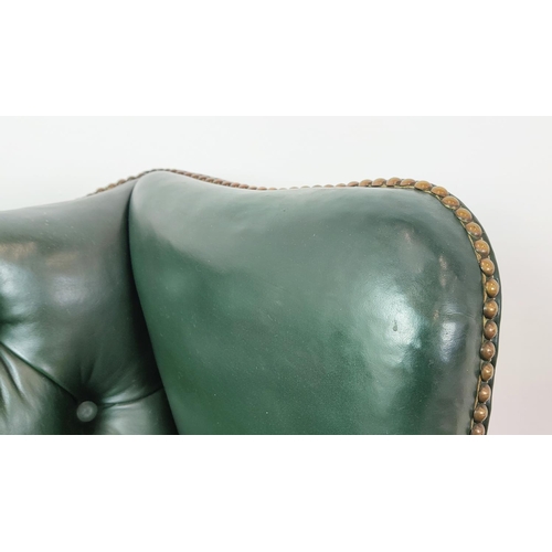 209 - A GEORGE III STYLE WING BACK ARMCHAIR, green leather, raised on cabriole legs with claw and ball fee... 