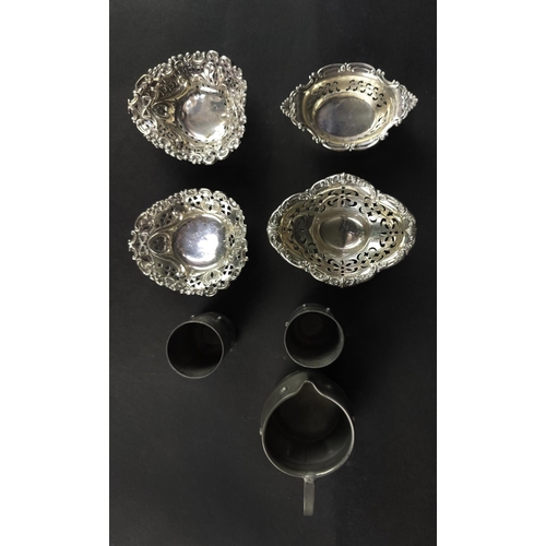 55 - SILVER SMALL DISHES, four pierced, and three items of Pewter. (7)