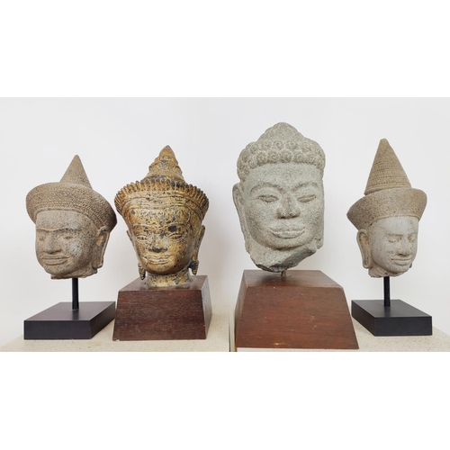 57 - SCULPTURE, four Asian heads, each on stand.