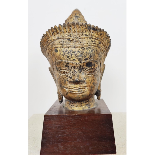 57 - SCULPTURE, four Asian heads, each on stand.