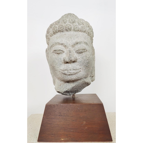 57 - SCULPTURE, four Asian heads, each on stand.