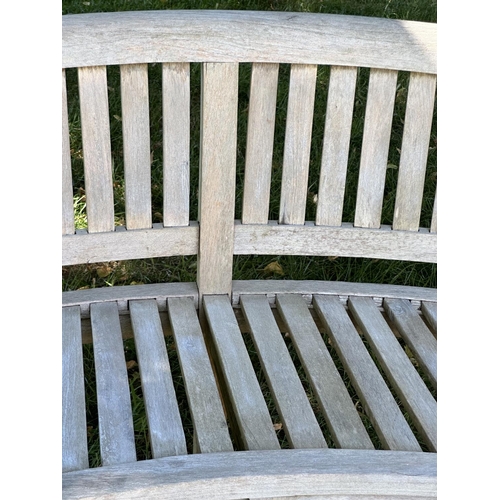 193 - BANANA GARDEN BENCH, well weathered teak, slatted and dowelled with curved back, 160cm W.