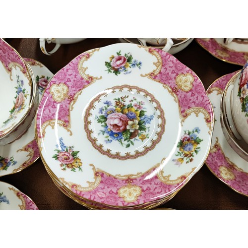 12 - A ROYAL ALBERT 'LADY CARLYLE' DINNER AND TEA SERVICE, comprising tea cups and saucers, coffee cups a... 