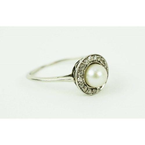 17 - A PLATINUM PEARL AND DIAMOND DRESS RING, set with a central pearl surrounded by small round old mine... 