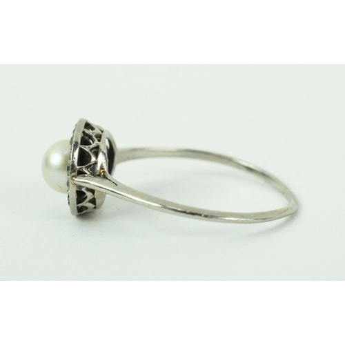 17 - A PLATINUM PEARL AND DIAMOND DRESS RING, set with a central pearl surrounded by small round old mine... 