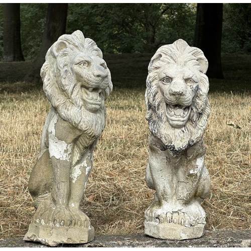 188 - GARDEN LIONS, a pair, well weathered reconstituted stone with old paint, 52cm H. (2)