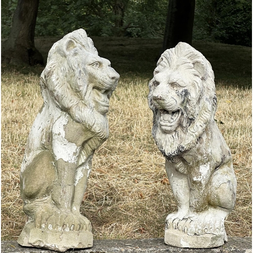 188 - GARDEN LIONS, a pair, well weathered reconstituted stone with old paint, 52cm H. (2)