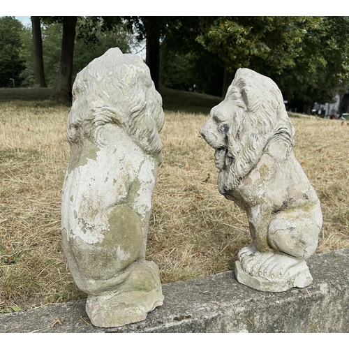 188 - GARDEN LIONS, a pair, well weathered reconstituted stone with old paint, 52cm H. (2)