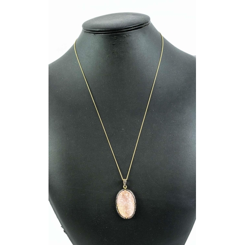 19 - A LARGE HAND-CARVED ROSE QUARTZ PENDANT, with diamond set halo, gold plated back, silver-gilt chain,... 