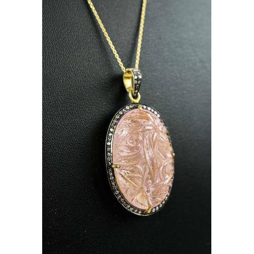 19 - A LARGE HAND-CARVED ROSE QUARTZ PENDANT, with diamond set halo, gold plated back, silver-gilt chain,... 