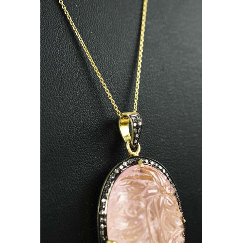 19 - A LARGE HAND-CARVED ROSE QUARTZ PENDANT, with diamond set halo, gold plated back, silver-gilt chain,... 