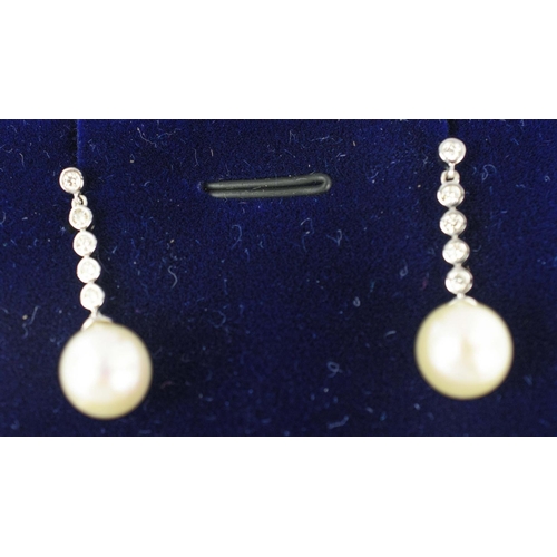 23 - A PAIR OF 9CT WHITE GOLD CULTURED PEARL DROP EARRINGS, each with diamond set bales, diamonds with a ... 