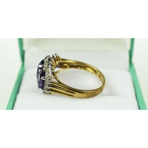 24 - A 9CT YELLOW GOLD AMETHYST THREE STONE TRILOGY RING, having three faceted amethysts, surrounded by d... 