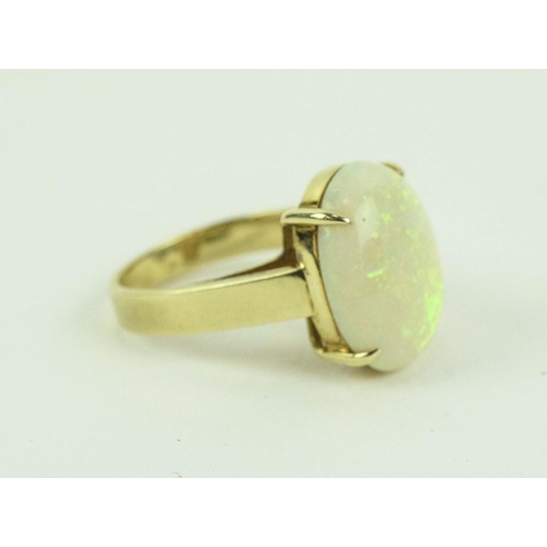 26 - A 14CT YELLOW GOLD OPAL SET DRESS RING, the large cabouchon opal of approximately 3 carats, claw set... 