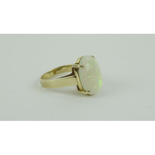 26 - A 14CT YELLOW GOLD OPAL SET DRESS RING, the large cabouchon opal of approximately 3 carats, claw set... 