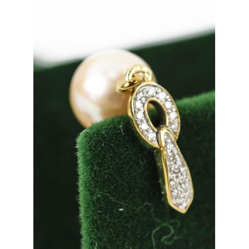 29 - A PAIR OF 9CT YELLOW GOLD DROPLET EARRINGS, set with suspended pink coloured pearls, diamond set bal... 