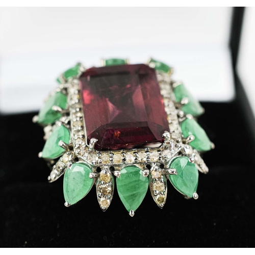 36 - A TOURMALINE, EMERALD AND DIAMOND DRESS RING, the central purple step cut tourmaline surrounded by a... 