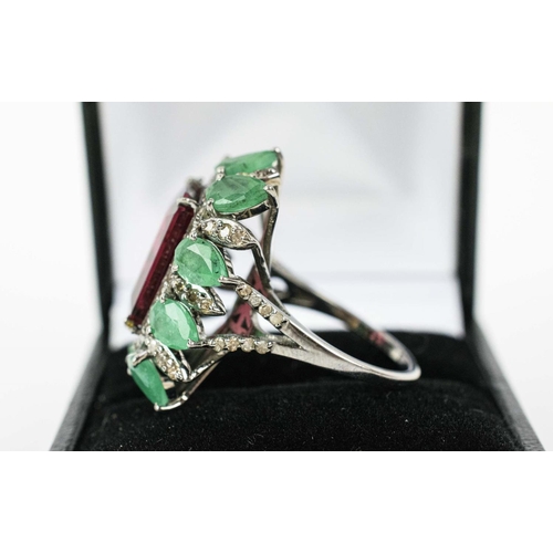 36 - A TOURMALINE, EMERALD AND DIAMOND DRESS RING, the central purple step cut tourmaline surrounded by a... 