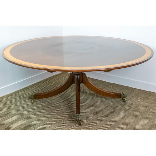 413 - DINING TABLE, Georgian style mahogany, satinwood and rosewood with circular top on brass castors, 74... 