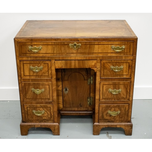 150 - KNEEHOLE DESK, George II walnut, circa 1735, with eight drawers around a recessed door, 70cm H x 78c... 