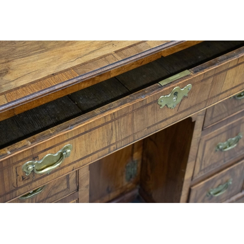 150 - KNEEHOLE DESK, George II walnut, circa 1735, with eight drawers around a recessed door, 70cm H x 78c... 