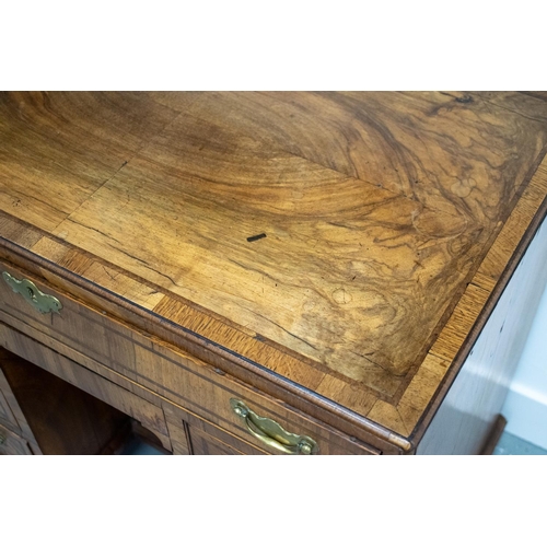 150 - KNEEHOLE DESK, George II walnut, circa 1735, with eight drawers around a recessed door, 70cm H x 78c... 