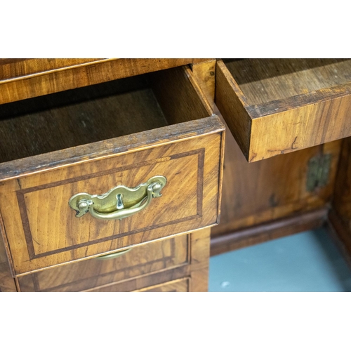 150 - KNEEHOLE DESK, George II walnut, circa 1735, with eight drawers around a recessed door, 70cm H x 78c... 