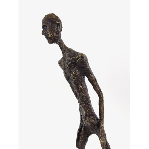 377 - CONTEMPORARY SCHOOL SCULPTURE, bronze of an elongated figure, 45cm H x 28cm L x 11cm W.