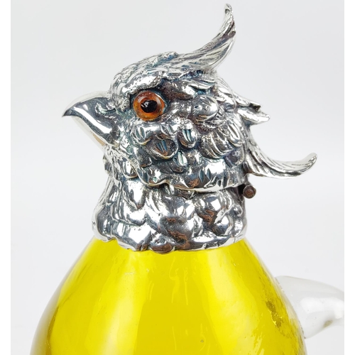 381 - CLARET JUG, in the form of a parrot, polished metal and yellow glass, 27cm H.