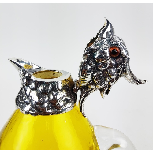 381 - CLARET JUG, in the form of a parrot, polished metal and yellow glass, 27cm H.