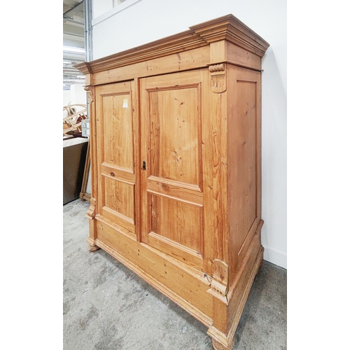 139 - PINE ARMOIRE, 19th century German, with a pair of panelled doors enclosing a hanging rail and shelf,... 