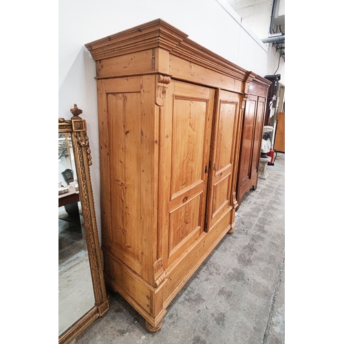 139 - PINE ARMOIRE, 19th century German, with a pair of panelled doors enclosing a hanging rail and shelf,... 