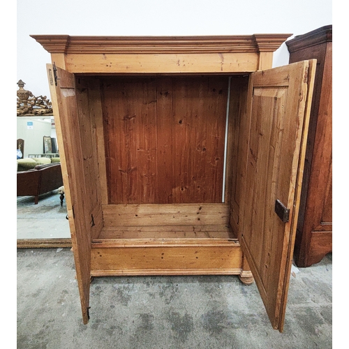 139 - PINE ARMOIRE, 19th century German, with a pair of panelled doors enclosing a hanging rail and shelf,... 