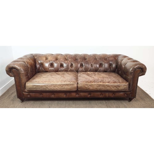 176 - CHESTERFIELD SOFA, brown leather on front castors, 73cm H x 223cm W x 100cm D.