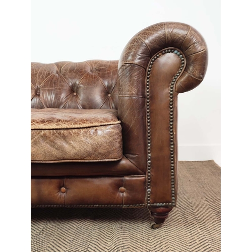 176 - CHESTERFIELD SOFA, brown leather on front castors, 73cm H x 223cm W x 100cm D.