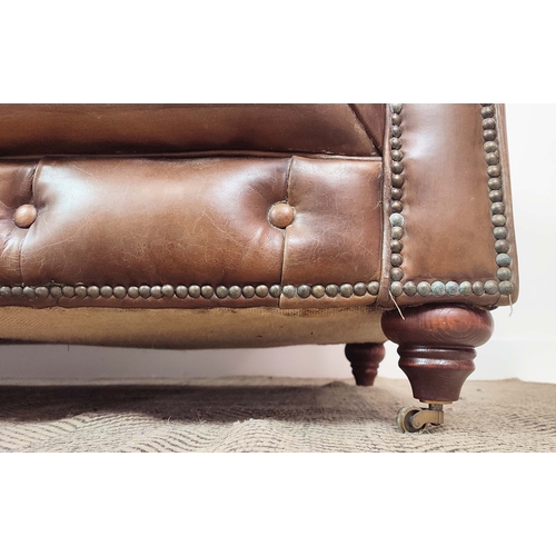 176 - CHESTERFIELD SOFA, brown leather on front castors, 73cm H x 223cm W x 100cm D.