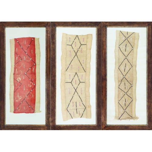 8 - AFRICAN KUBA CLOTHS, a set of three, purchased from the Trowbridge Gallery, 133cm x 63cm, framed.