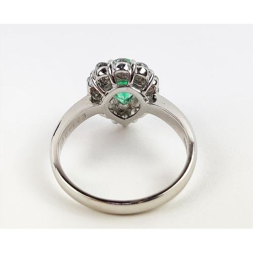 18 - A PLATINUM EMERALD AND DIAMOND DRESS RING, the pear shaped emerald surrounded by a border of ten dia... 