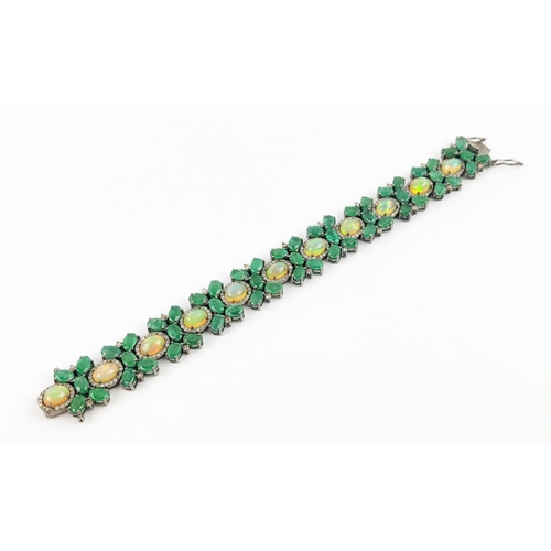 19 - A LARGE EMERALD, OPAL AND DIAMOND SET BRACELET, set with oval opals, emeralds, and round brilliant c... 