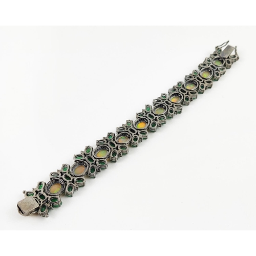 19 - A LARGE EMERALD, OPAL AND DIAMOND SET BRACELET, set with oval opals, emeralds, and round brilliant c... 