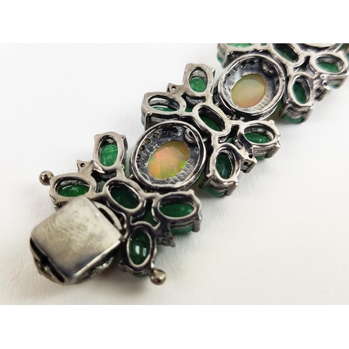 19 - A LARGE EMERALD, OPAL AND DIAMOND SET BRACELET, set with oval opals, emeralds, and round brilliant c... 