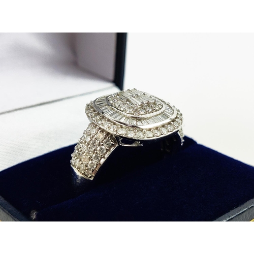 20 - A WHITE GOLD DIAMOND CLUSTER GENTS RING, 9ct gold shank, baguette cut and round brilliant cut stones... 