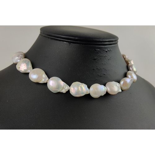 21 - A BAROQUE FRESHWATER PEARL NECKLACE, with brushed gold plated hoop clasp, 44cm / 17.5 inches long.