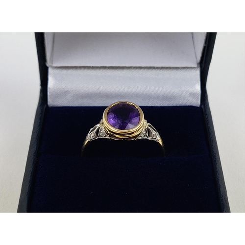 23 - A YELLOW METAL AMETHYST AND DIAMOND DRESS RING, early 20th century, likely to be high carat gold, th... 