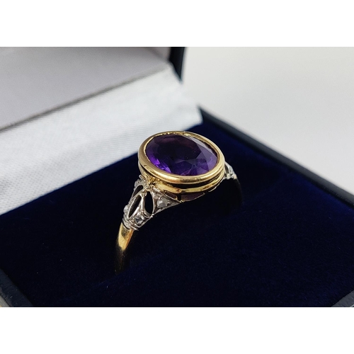 23 - A YELLOW METAL AMETHYST AND DIAMOND DRESS RING, early 20th century, likely to be high carat gold, th... 