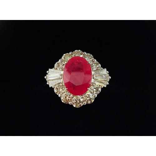 28 - A 18CT WHITE GOLD RUBY AND DIAMOND RING, the oval mixed cut ruby surrounded by a halo of round brill... 