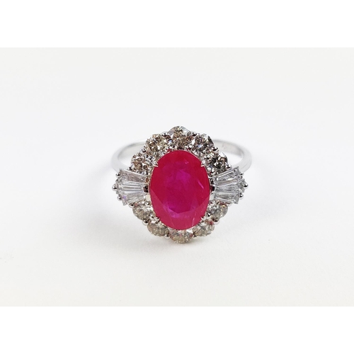 28 - A 18CT WHITE GOLD RUBY AND DIAMOND RING, the oval mixed cut ruby surrounded by a halo of round brill... 