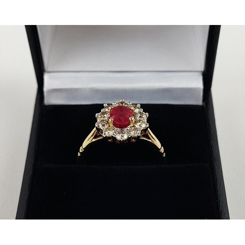 31 - A 9CT YELLOW GOLD RUBY AND DIAMOND RING, the mixed cut ruby of approximately 1 carat, surrounded by ... 